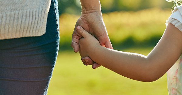 Mother and daughter holding hands
